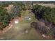 Aerial view highlighting storage buildings and green buildings bordered with lots of tall trees at 6404 Pulley Town Rd, Wake Forest, NC 27587