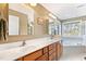 Bathroom with double sinks, and a soaking tub by a window offering natural light at 6404 Pulley Town Rd, Wake Forest, NC 27587