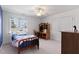 Bright bedroom featuring a ceiling fan, a window with backyard views, and a wooden furniture set at 6404 Pulley Town Rd, Wake Forest, NC 27587