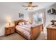 Cozy bedroom with a ceiling fan, a window with backyard views, and a wooden furniture set at 6404 Pulley Town Rd, Wake Forest, NC 27587