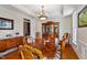 Traditional dining room with hardwood floors, decorative chandelier, and large wooden table at 6404 Pulley Town Rd, Wake Forest, NC 27587