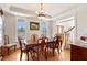 Traditional dining room featuring hardwood floors, a classic chandelier, and large windows for natural light at 6404 Pulley Town Rd, Wake Forest, NC 27587