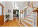 Bright entryway features hardwood floors, staircase, and view to a living space beyond at 6404 Pulley Town Rd, Wake Forest, NC 27587