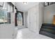 Bright entryway featuring white tile flooring, natural light, and staircase access to the upper level at 6404 Pulley Town Rd, Wake Forest, NC 27587
