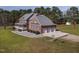 Brick home with an attached three car garage, manicured landscaping, and lush lawn at 6404 Pulley Town Rd, Wake Forest, NC 27587