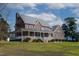 Beautiful two-story brick home with a wraparound porch and lush lawn at 6404 Pulley Town Rd, Wake Forest, NC 27587