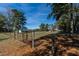A fenced property showcases rural living, featuring lush greenery and an outbuilding at 6404 Pulley Town Rd, Wake Forest, NC 27587
