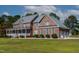 Charming brick home with a covered porch, three car garage, and well-maintained lawn at 6404 Pulley Town Rd, Wake Forest, NC 27587