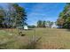 Exterior of a fenced property with a building and dog under a clear sky at 6404 Pulley Town Rd, Wake Forest, NC 27587