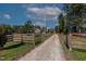 Long driveway leading to home. Wooden fence on one side, with metal gates on the other at 6404 Pulley Town Rd, Wake Forest, NC 27587