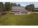 Charming brick home with a large porch and a well-manicured lawn, surrounded by mature trees at 6404 Pulley Town Rd, Wake Forest, NC 27587