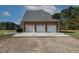 Three-car brick garage with ample parking space and a well-kept yard at 6404 Pulley Town Rd, Wake Forest, NC 27587