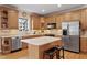 Spacious kitchen with stainless steel appliances, hardwood floors, and a center island, perfect for cooking and entertaining at 6404 Pulley Town Rd, Wake Forest, NC 27587