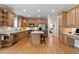 Open kitchen with stainless steel appliances, a center island, hardwood floors, and ample cabinet space at 6404 Pulley Town Rd, Wake Forest, NC 27587