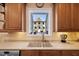 Kitchen features a sink with garden window above, under-cabinet lighting, and stainless steel appliances at 6404 Pulley Town Rd, Wake Forest, NC 27587