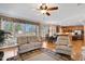 Spacious living area with natural light, hardwood floors, neutral tones, ceiling fan and a view into the kitchen at 6404 Pulley Town Rd, Wake Forest, NC 27587