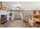 Bright living room with fireplace, large windows, hardwood floors and a view into the kitchen and dining area at 6404 Pulley Town Rd, Wake Forest, NC 27587