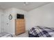 Bedroom featuring twin beds, a ceiling fan, and a dresser with a mounted television at 7031 Racine Way, Raleigh, NC 27615