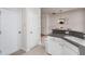 Bright kitchen with white cabinetry, stainless appliances and a view of dining area at 7031 Racine Way, Raleigh, NC 27615