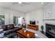 Comfortable living room featuring a fireplace, television and natural light at 7031 Racine Way, Raleigh, NC 27615