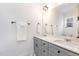 Well-lit bathroom with double sink vanity, stone counters, and decorative mirror at 727A Peyton Ave, Durham, NC 27703