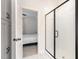 Modern bathroom with glass shower and bedroom access exudes style and functionality at 727A Peyton Ave, Durham, NC 27703