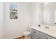 Elegant powder room features a modern vanity with stone countertop and ample light at 727A Peyton Ave, Durham, NC 27703