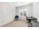 Bright bedroom featuring a desk, plush chair, and stylish accent wall at 727A Peyton Ave, Durham, NC 27703