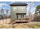 Exterior back view of a home with a wooden deck, fenced yard, and fresh landscaping at 727A Peyton Ave, Durham, NC 27703