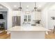 This bright kitchen features an eat-in island and stainless steel refrigerator at 727A Peyton Ave, Durham, NC 27703