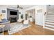 Open-concept living room with fireplace, hardwood floors, and views into the kitchen at 727A Peyton Ave, Durham, NC 27703