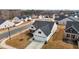 Aerial view of a home showcasing its manicured lawn, spacious driveway, and neighborhood setting at 82 Coble Farms Pl, Fuquay Varina, NC 27526
