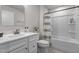 Neat bathroom with a shower-tub combo, white vanity, and neutral decor for a clean, modern feel at 82 Coble Farms Pl, Fuquay Varina, NC 27526