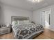 Bedroom featuring modern lighting, neutral color palette, and wood-look flooring at 82 Coble Farms Pl, Fuquay Varina, NC 27526