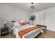 Bright bedroom with a wooden floor, lamps, bench, and stylish accents, creating a serene retreat at 82 Coble Farms Pl, Fuquay Varina, NC 27526