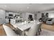 Open concept kitchen and dining area with seating at the island and a dining table at 82 Coble Farms Pl, Fuquay Varina, NC 27526