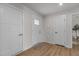 Inviting entryway with neutral walls, wood flooring, and white doors provide a welcoming space at 82 Coble Farms Pl, Fuquay Varina, NC 27526