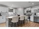 Beautiful kitchen island with light countertops, white cabinets, stainless steel appliances, and barstool seating at 82 Coble Farms Pl, Fuquay Varina, NC 27526