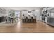 Open kitchen and dining area with a large center island, stainless steel appliances, and ample seating space at 82 Coble Farms Pl, Fuquay Varina, NC 27526