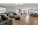 Open-concept living area with a gray leather sofa, dining area, and kitchen bar seating for entertaining at 82 Coble Farms Pl, Fuquay Varina, NC 27526