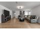 Spacious living room with a comfortable gray leather sectional sofa, fireplace, and modern lighting at 82 Coble Farms Pl, Fuquay Varina, NC 27526