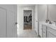 Spacious walk-in closet featuring organized shelving and ample storage, with an adjoining bathroom at 82 Coble Farms Pl, Fuquay Varina, NC 27526