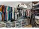 Organized walk-in closet with hanging racks, shelves, and storage bins to maximize space at 82 Coble Farms Pl, Fuquay Varina, NC 27526