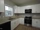 Well-lit kitchen with granite counters, stainless steel appliances, and white cabinets at 821 Brookhannah Ct, Fuquay Varina, NC 27526