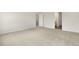 Spacious bedroom with soft carpeting and views into a bathroom and the hallway at 871 Forth Ct, Gibsonville, NC 27249