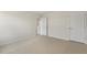 Bright bedroom with neutral carpeting and views into a hallway and closet at 871 Forth Ct, Gibsonville, NC 27249