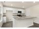 Open kitchen featuring a large island, granite countertops, and white cabinetry at 871 Forth Ct, Gibsonville, NC 27249