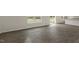 Open living area showcasing hardwood floors, a window view, and access to the kitchen and patio at 871 Forth Ct, Gibsonville, NC 27249