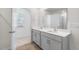 Bright bathroom featuring a double sink vanity with quartz countertop and neutral color palette at 879 Forth Ct, Gibsonville, NC 27249