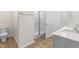 Bathroom includes double sinks, a glass shower, and a toilet with modern fixtures at 879 Forth Ct, Gibsonville, NC 27249